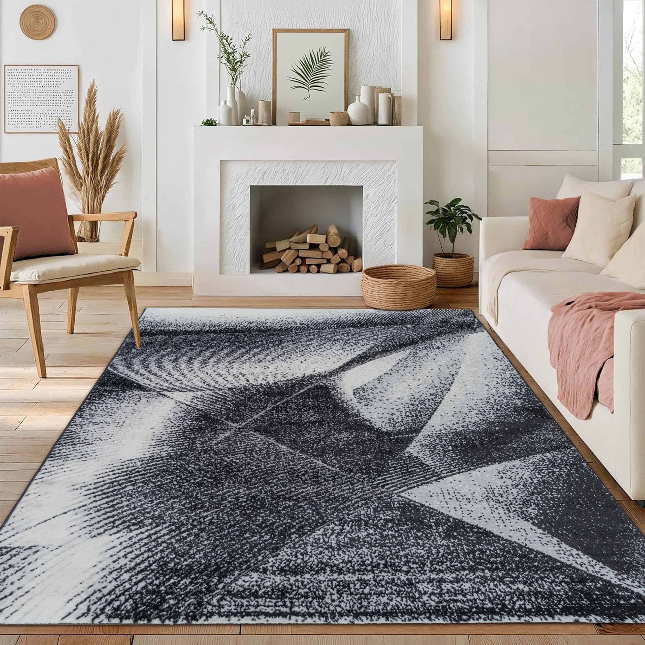 Modern medium-pile Black Cascade Turkish rug with a geometric black and gray design, placed in a cozy room featuring a fireplace, chair, and sofa