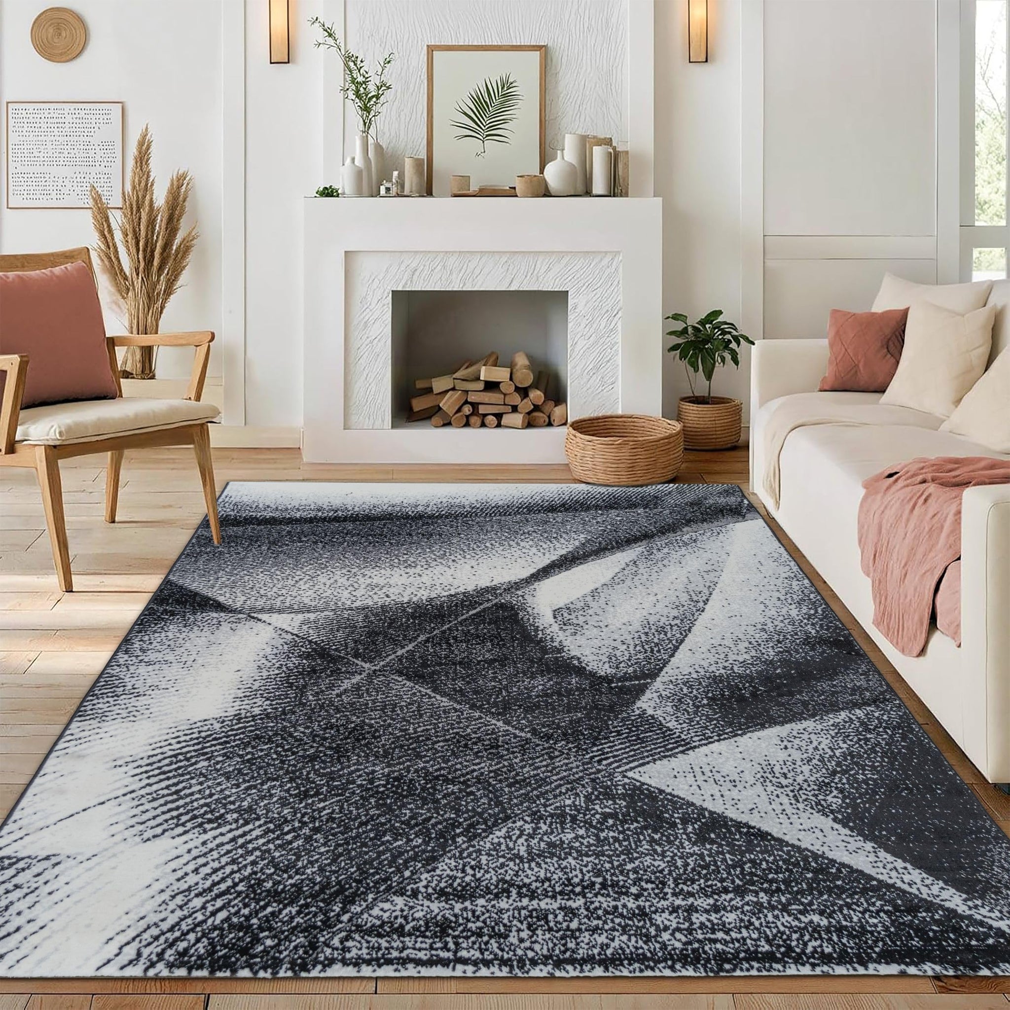 Modern medium-pile Black Cascade Turkish rug with a geometric black and gray design, placed in a cozy room featuring a fireplace, chair, and sofa